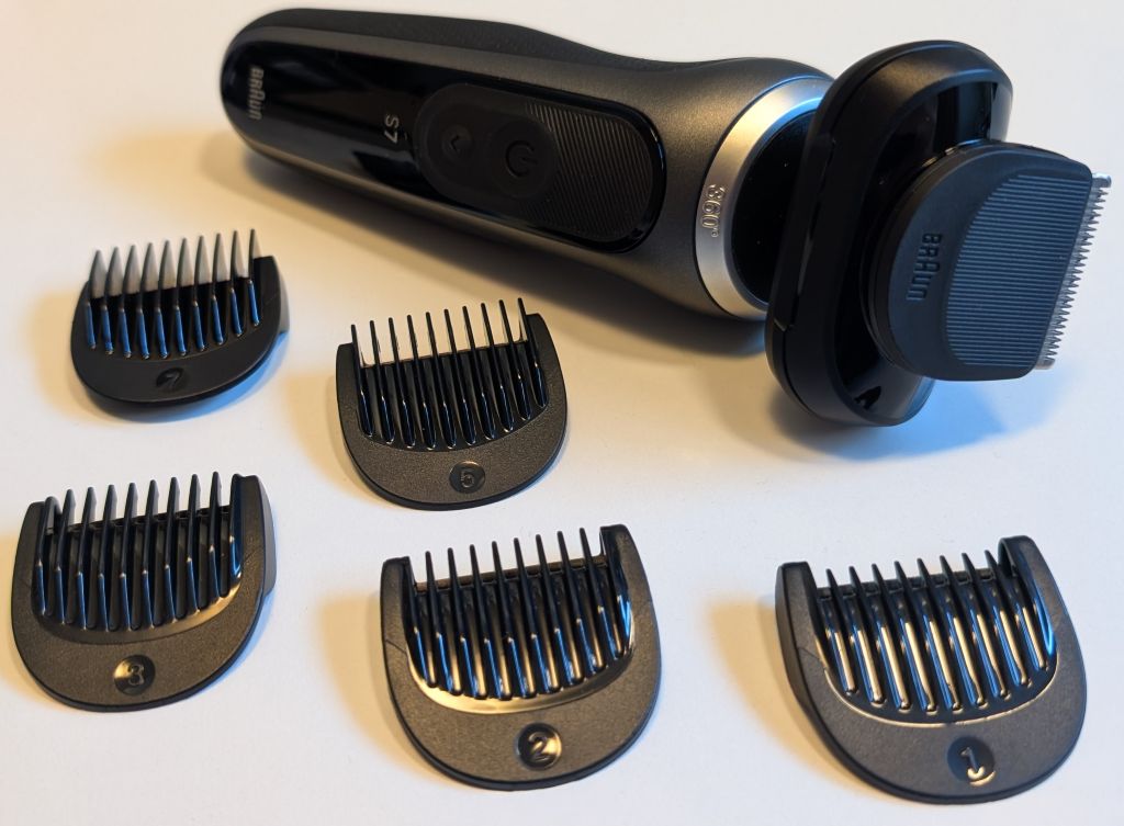 Braun Series 7 with the beard trimmer attached and the 5 combs laying next to it