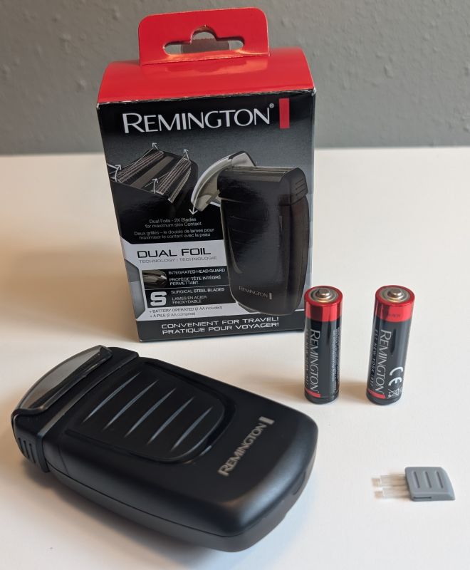 everything included with the travel shaver from Remington: shaver, tiny brush, and 2 AA batteries