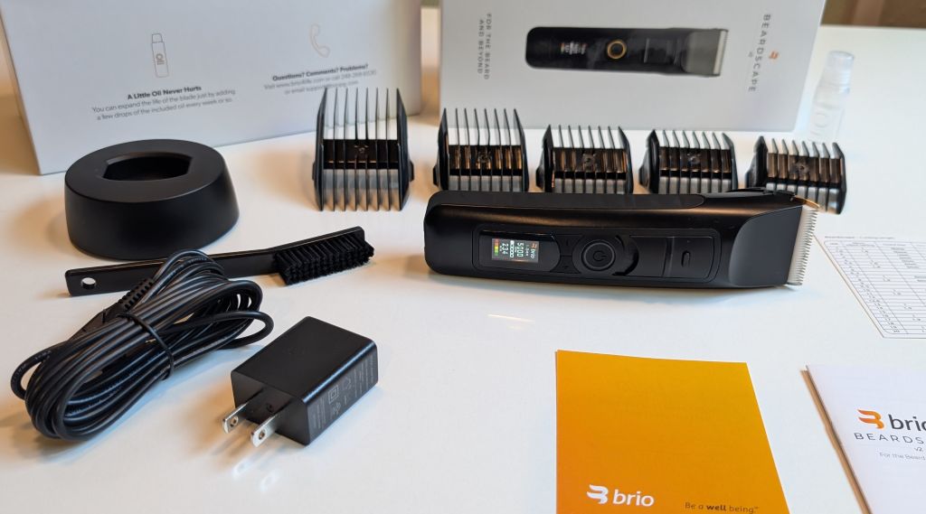 everything inside the box of the Brio Beardscape v2, stand, trimmer, guards, brush, charging cord, and docs